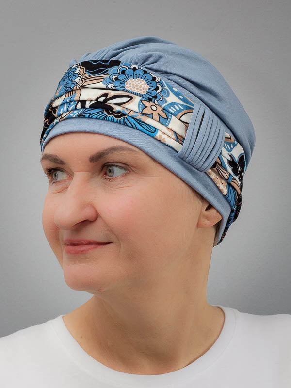 Breathable bamboo blue hat with a floral band, perfect for sensitive scalps and hair loss