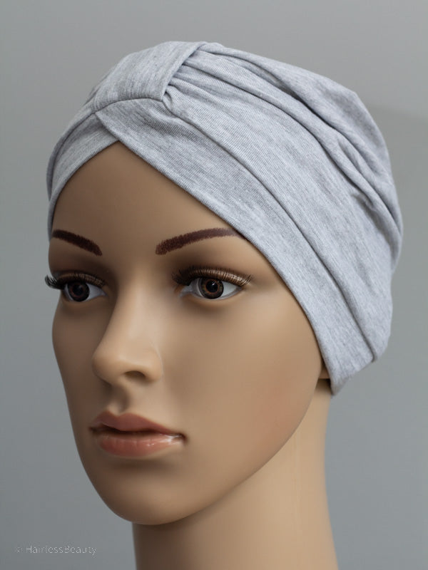 Stylish Marigold turban with decorative band, gentle on sensitive scalps from chemo